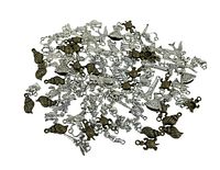 Top-down photo of assorted silver and bronze plated charms and pendants spread out showing variety of designs and finishes