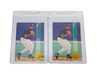 Photo of front sides of two identical Alex Rodriguez rookie baseball cards in protective sleeves showing him in Chicago White Sox uniform in defensive stance.