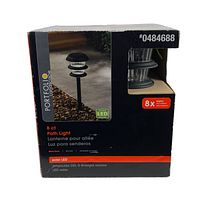 Box of Portfolio solar LED path lights containing eight pieces, showing product image, branding, and key product info including solar LED, black finish, item number 0484688.