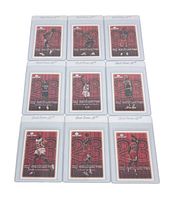 Full lot of nine Michael Jordan NBA cards arranged in a 3 by 3 grid, all in plastic protective sleeves. Cards have red background with Jordan's image and number 23.