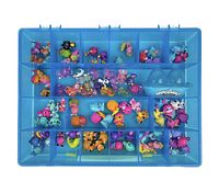 Top-down view of the blue plastic case filled with 86 assorted Hatchimals CollEGGtibles mini figures organized by compartments.