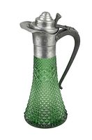 Green vintage pitcher with textured diamond pattern hobnail glass body, metal hinged lid, and curved metal handle. Side angled view showing shape and handle.