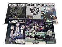 Vintage Raiders magazines with covers showing team logos, Super Bowl trophies, and a player.