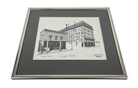 Framed black and white line drawing of the International Hotel building signed by Dan Heath with 'Artist Proof' notation.