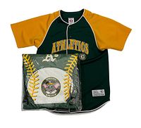 Photo showing Oakland Athletics kids jersey alongside Kids Club Stomper backpack featuring baseball design and mascot patch on front pouch, packaged in plastic.