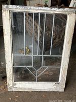 Vintage leaded glass window panel measuring approximately 20.25" x 27" with vertical and angled lead lines and aged white wooden frame showing chipping paint.