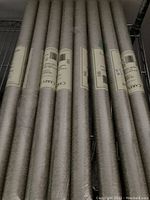 Eight wallpaper rolls with visible Carey Lind labels arranged side by side