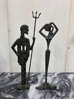 Front view of the two metal brutalist style figures, showing overall condition and height