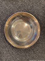Top view of silver bowl showing pierced lattice work around sides and polished center