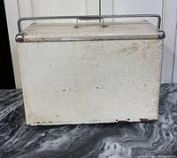 Front view showing white textured metal cooler body with signs of wear and rust.