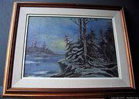 Frontal view of the framed oil painting showing moonlit creek with trees and atmospheric lighting.