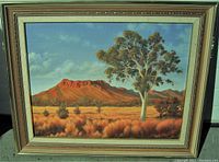 Frontal image showing the full framed oil painting of Razor Back Range at Alice Springs with a eucalyptus tree in the foreground and red mountains in the background.