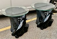 Front angled view of both tables outdoors on asphalt with vehicle behind