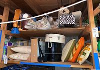 Shelving unit with pillows, storage containers, rolled fabric or paper sheets, hat box and travel case