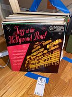 Vinyl records collection with the front album titled Jazz at the Hollywood Bowl visible, showing a black cover with red and yellow text.