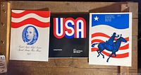 Three United States Postal Service special stamp mini albums from 1971, 1972, and 1973 placed side by side on a wooden surface.