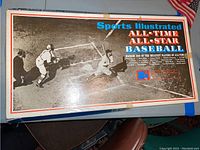 Top of the game box showing the title 'Sports Illustrated ALL-TIME ALL-STAR BASEBALL' with a black and white baseball action photo background.