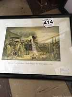 Framed print depicting 1857 train departure scene with Native American chiefs and passengers under glass in a black frame; title 'Captain Todd & Sioux Chiefs Depart for Washington – 1857' visible on print