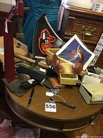 Top view of table showing vintage tools and decorations including iron logo, ceramic moose, and hammer.