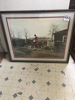 Full view of framed print showing hunter on horse with hounds in an outdoor setting.