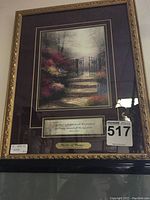 Full view of framed Thomas Kinkade print 'Garden of Promise' with ornate gold frame, double mat, brass plaque and scripture quote visible.