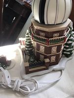 Lighted bisque figurine of The Old Royal Observatory with power cord visible, showing its design and lighting dome