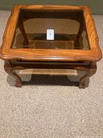 Top view showing wooden frame around inset glass top surface of the side table