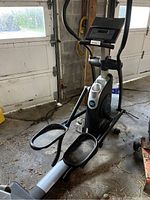 Full view of the XP 600 stair climber machine showing its black and silver color, dual wide foot pedals, and the digital display console at the top.
