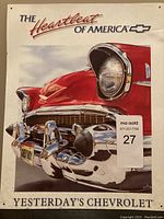 Front view of the metal sign showing classic red Chevrolet car front and branding text