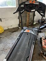Full front view of the treadmill showing walking belt, handrails and base.
