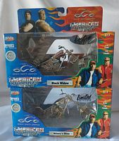 Two boxed American Chopper die cast models, Black Widow on top and Mikey's Bike below, both in blue packaging with collector and limited edition branding.