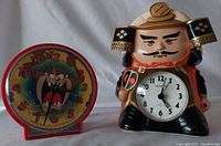 Photo showing the Tasmanian Devil Westclox alarm clock on the left and the Samurai Citizen quartz clock on the right.