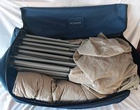 Packed bed components inside near new blue Columbia carrying case with visible damage