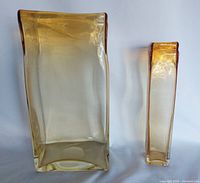 Front view of both handblown glass vases showing size difference, color, and shape details