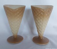 Two glass waffle cone sundae cups standing upright to show shape and design