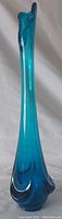 Front angled view of the tall blue glass vase showing its outline, seams, and base shape.