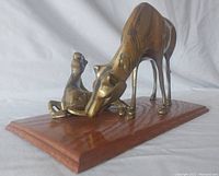 Angle showing the horse and foal brass statue mounted on wooden base with visible patina and detailing on figures