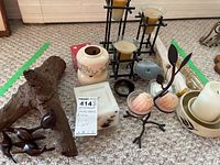 Overview photo showing all items in the lot including candle holders, ceramic containers, carved wood figurines, and candles.