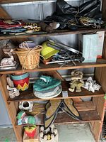 Shelved collection showing multiple garden decor items including animal figurines, pots, baskets, and miscellaneous items