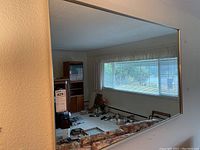 Front view of the large rectangular wall mirror showing full reflective surface and room reflection.