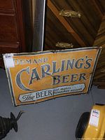 Front overview of sign leaning against furniture showing full design, text and wear