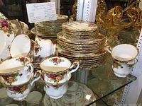 Overview of eight place settings showing multiple cups and stacks of plates