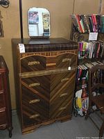 Front view of the vintage wood veneer 4-drawer high boy dresser with removable tilting mirror positioned on top.