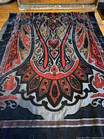 Full view of scarf showing rich red, grey, and black velvet pattern on black chiffon background.