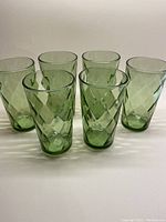 Front view of all six green tumblers arranged in two rows showing the diamond optic texture and shape.