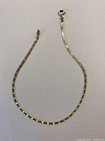full view of gold rectangular snake chain bracelet with spring ring clasp
