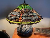 Front view of lamp showing stained glass shade and glass base