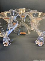 Eight clear Nachtmann crystal martini or cocktail glasses arranged with visible stems and signature linear indentations.