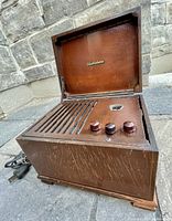 Front angle view showing the radio controls, tuning dial, and Electrohome branding inside lid.