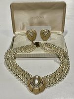 Full view of the Vendome necklace and earrings set in its box showing the faux pearl strands and the pendant with rhinestones.
